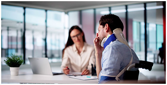 Personal injury consultation: man in neck brace meeting.