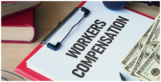Workers' Compensation documents, money, and law book.